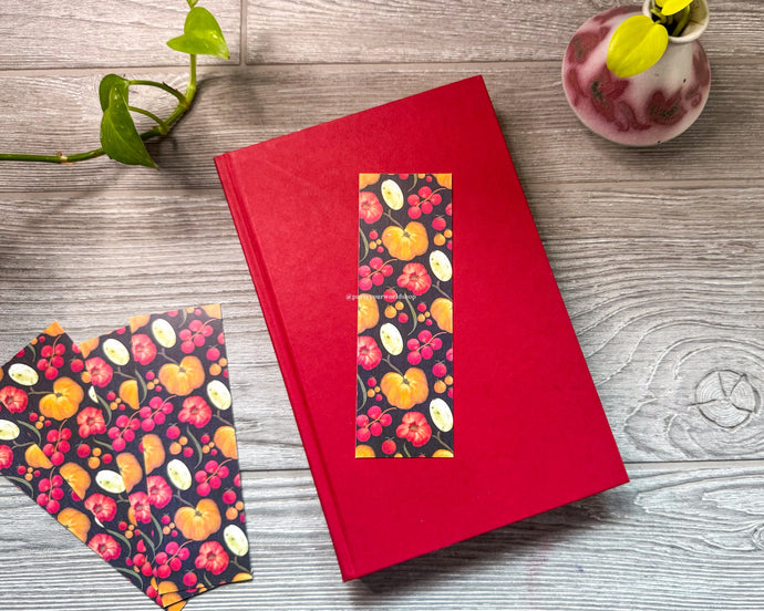 Red book with tomato pattern on a wooden surface