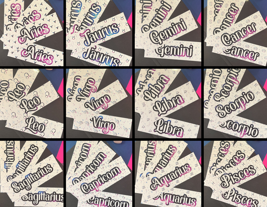 A 3x4 grid of 152 close-up product photos showing multiple cream-colored bookmarks with zodiac names in stylized black, pink, and blue lettering. The visible zodiac signs include Aries, Taurus, Gemini, Cancer, Libra, Scorpio, Sagittarius, Aquarius, Capricorn, and Pisces.